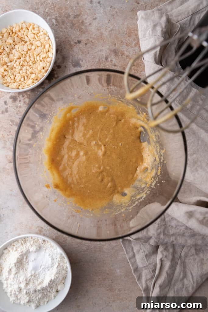 All wet ingredients creamed together in a bowl, appearing smooth and well-combined.