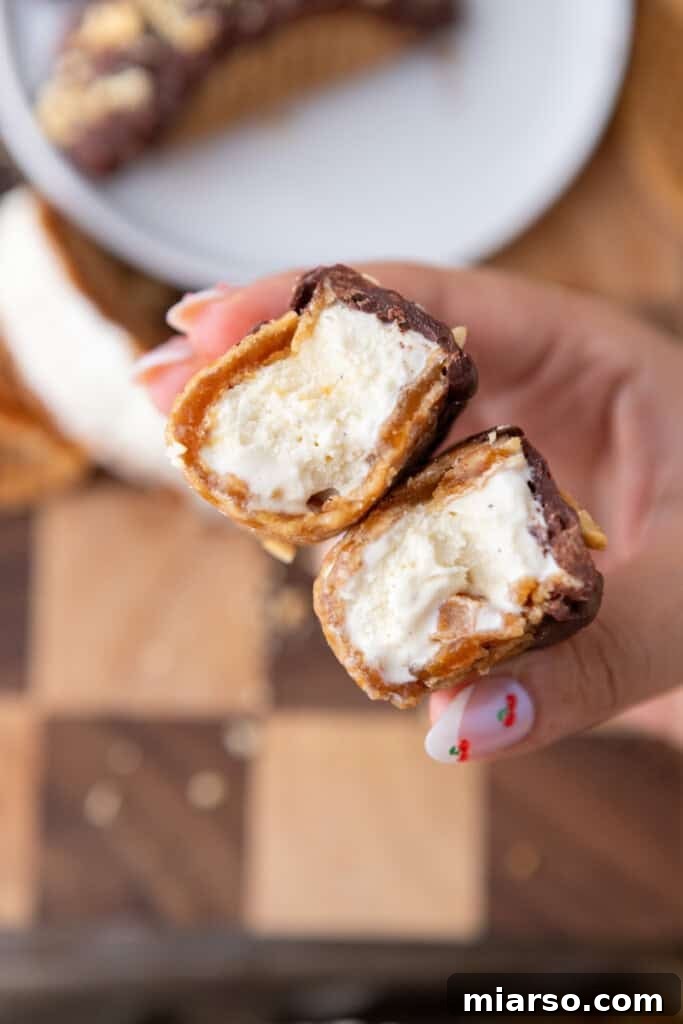 Stroopwafel Choco Tacos split in half, revealing creamy ice cream and caramel filling