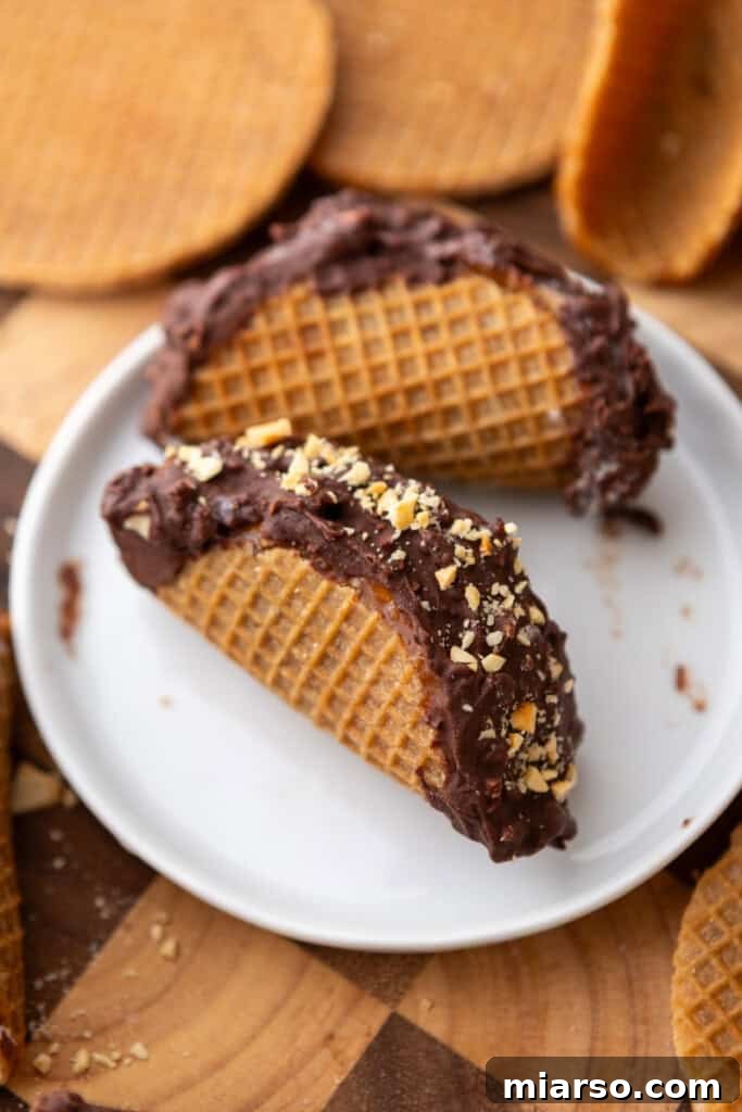 A close-up of a Stroopwafel Choco Taco, highlighting its textured chocolate and peanut coating