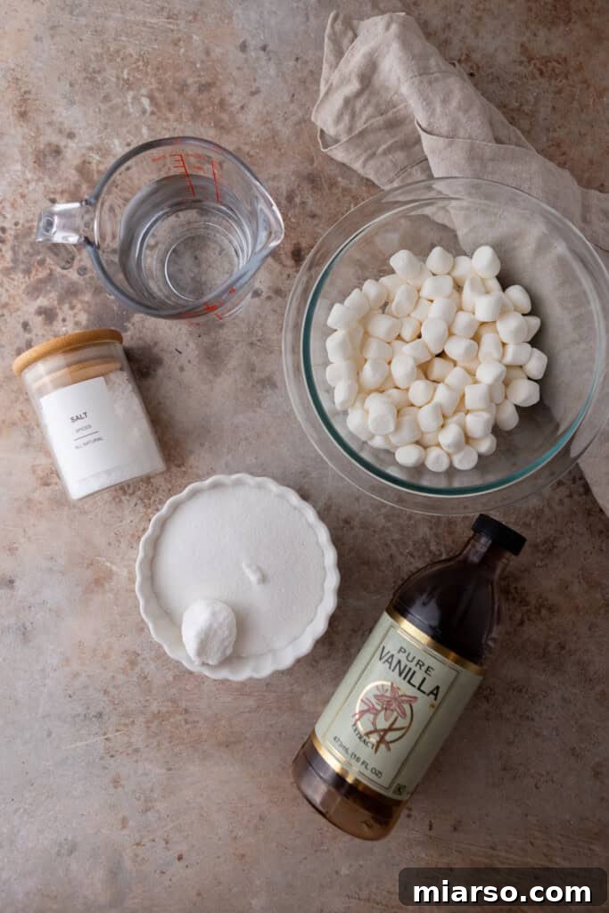 Essential ingredients for homemade toasted marshmallow syrup laid out on a clean surface.