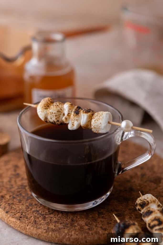 A delicious coffee drink topped with toasted marshmallows, ready to be enjoyed.