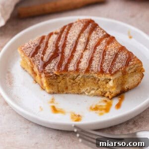 Churro Pumpkin cheesecake bars on a plate with a bite taken out