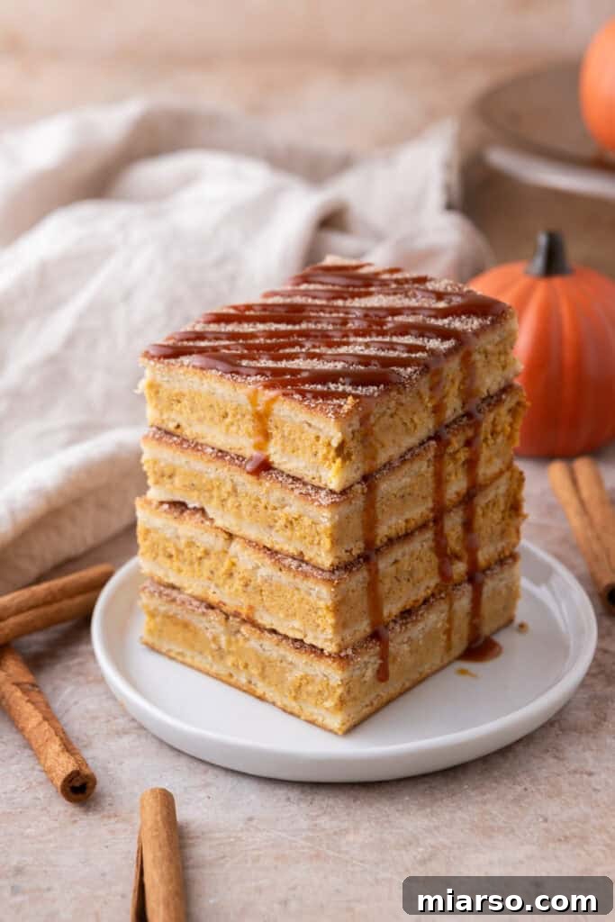 Stack of freshly baked churro pumpkin cheesecake bars
