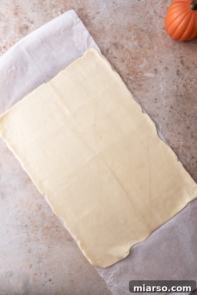 Croissant dough pressed evenly into the bottom of the baking pan
