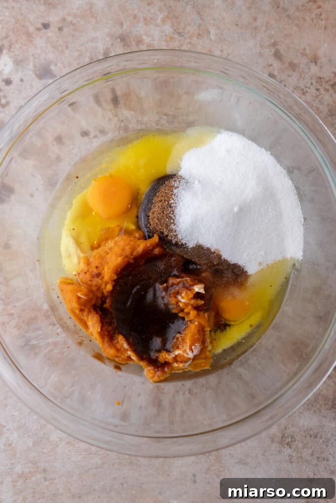 Warm Autumn Pumpkin Streusel Loaf 8 wet ingredients in a bowl