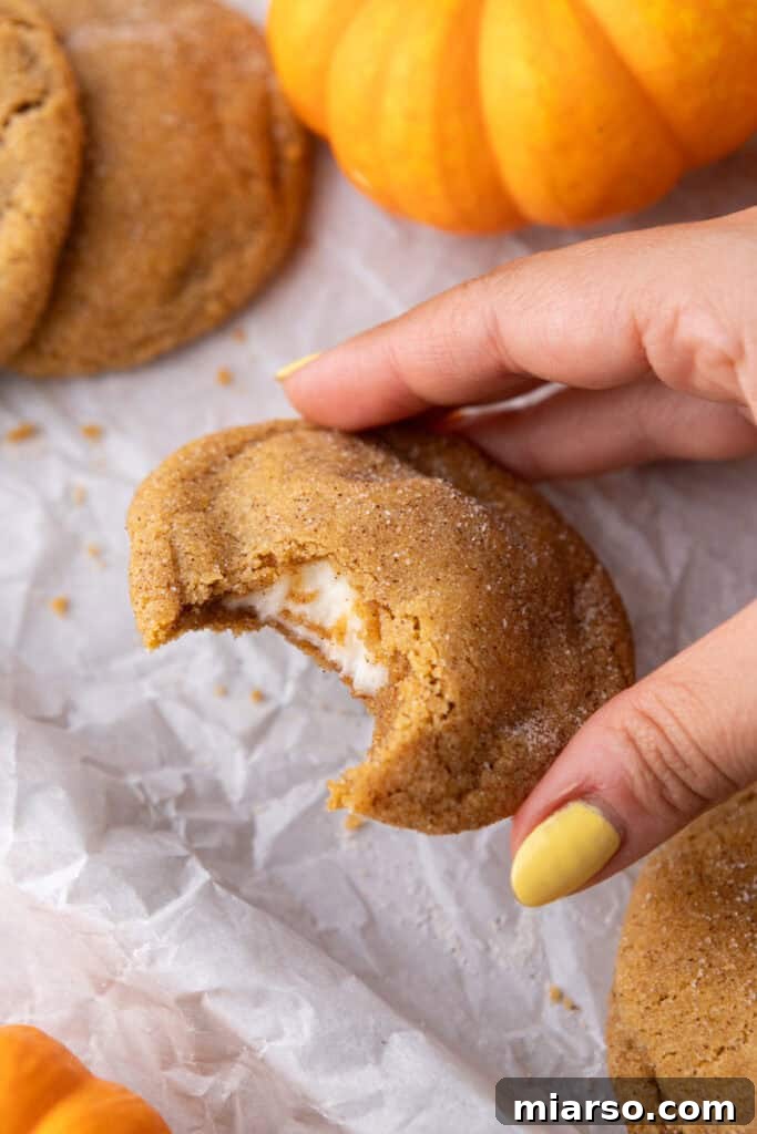 Luscious Pumpkin Cheesecake Cookies 17 Pumpkin Cheesecake Cookie being picked up by a hand