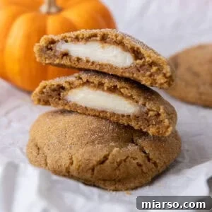 Luscious Pumpkin Cheesecake Cookies 19 Pumpkin Cheesecake Cookies stacked on each other