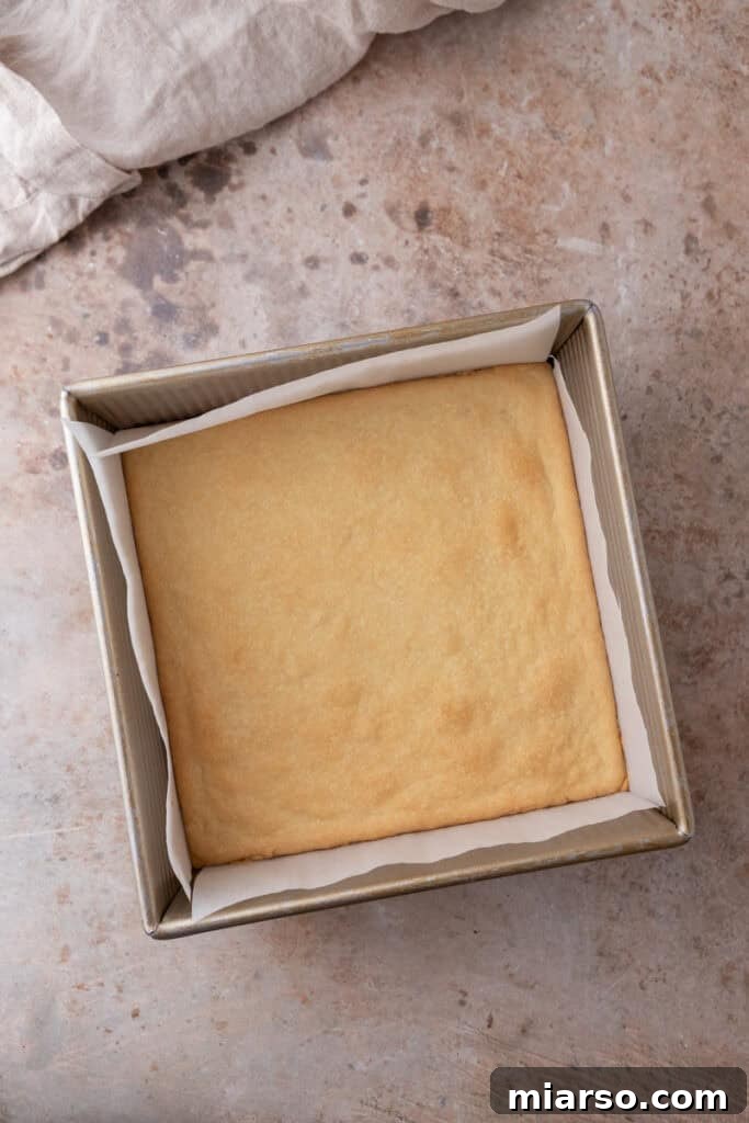 The golden and perfectly pre-baked shortbread crust resting in a baking pan, ready for the filling.
