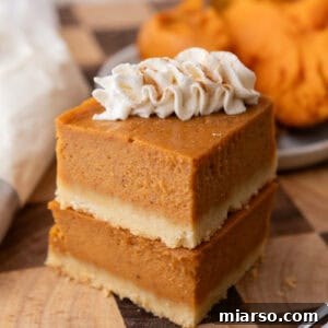 Stack of perfectly baked sweet potato pie bars with shortbread crust on a plate, ready to be served.