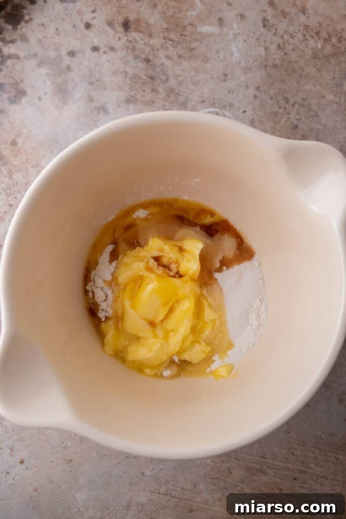 Dry ingredients for the shortbread crust, including flour, sugar, and cornstarch, meticulously placed in a mixing bowl.