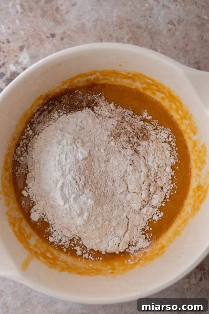 Soft Bakery Pumpkin Muffins Inspired by Panera 9 wet and dry ingredients in a bowl