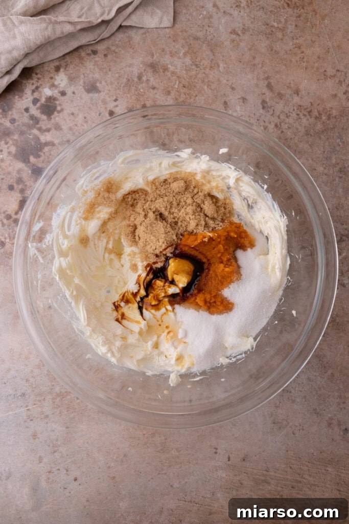 Little Pumpkin Spice Cheesecake Cups 13 filling ingredients in a bowl