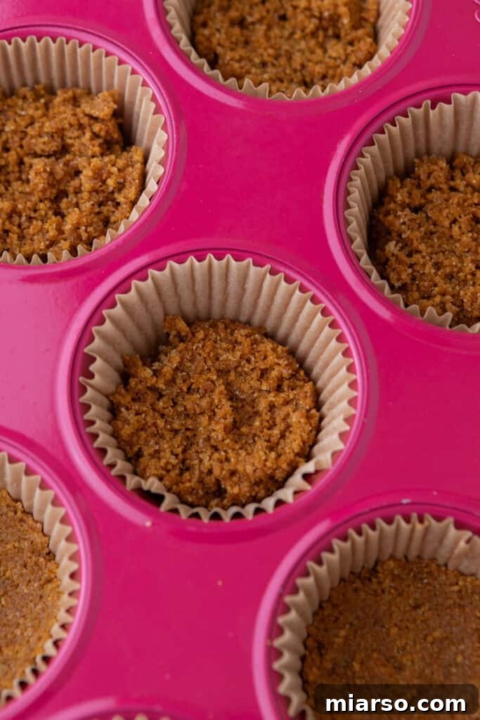 Little Pumpkin Spice Cheesecake Cups 8 crust mixture in muffin liners