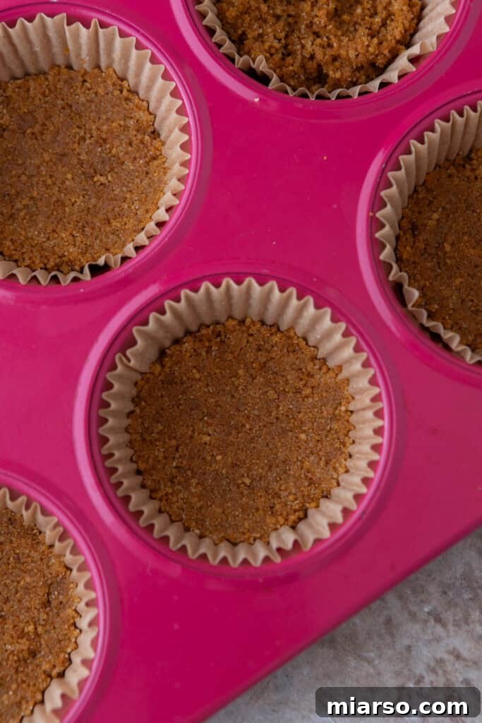 Little Pumpkin Spice Cheesecake Cups 9 crust mixture in muffin liners