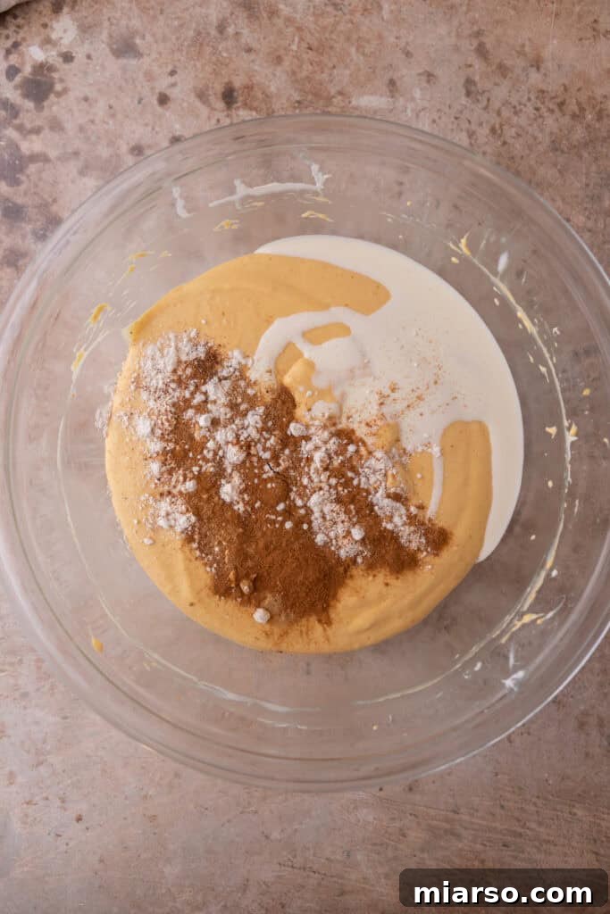 Little Pumpkin Spice Cheesecake Cups 10 filling ingredients in a bowl
