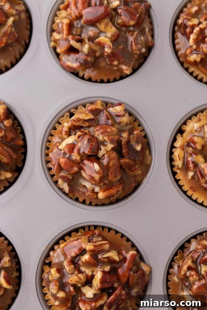 Close-up of finished Mini Pecan Pie Cheesecakes, ready to be served or refrigerated for later enjoyment.