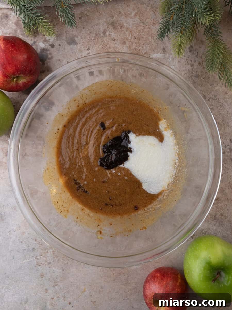Apple butter and buttermilk added to wet ingredients for apple cider donuts.