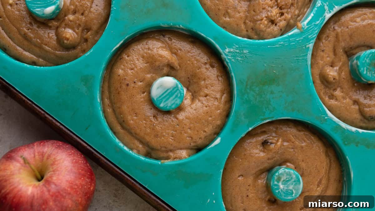 Batter piped into a deep-well donut pan before baking.
