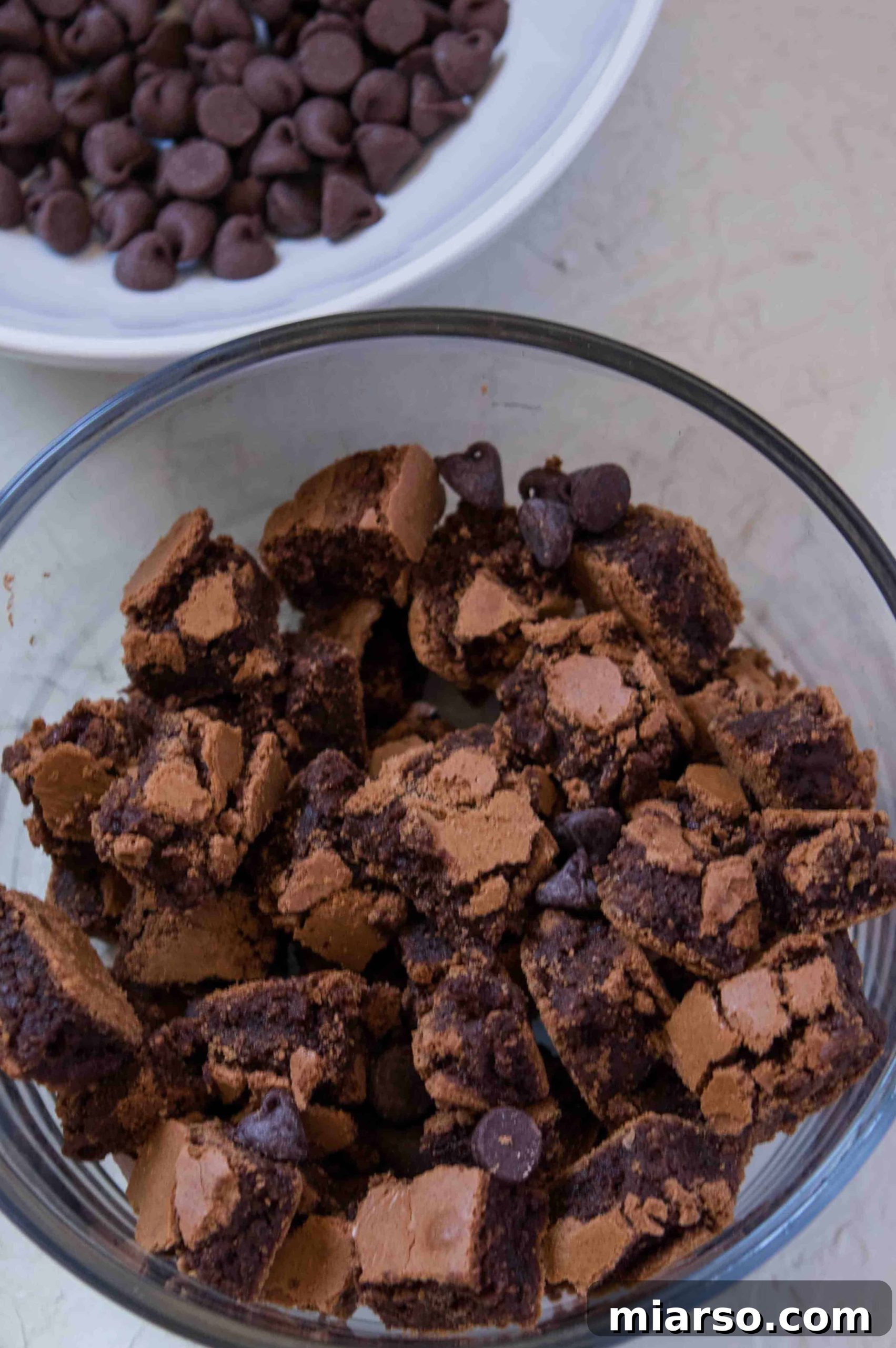 Various ingredients for homemade chocolate ice cream laid out on a surface.