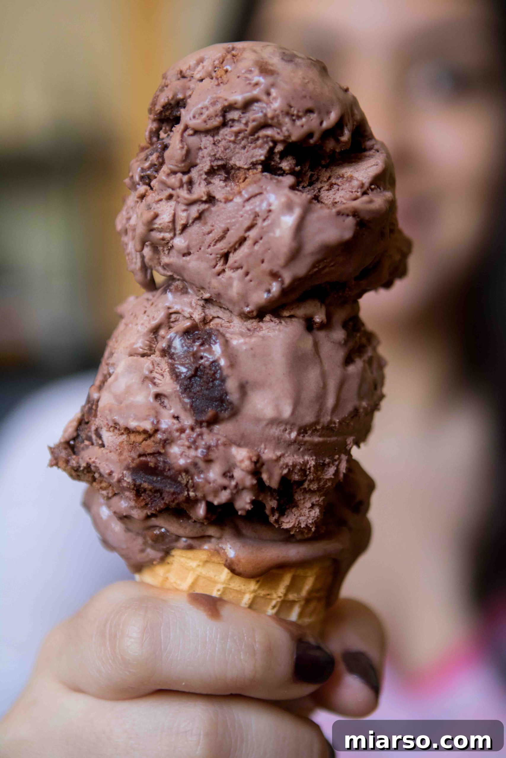 Close-up of a scooped homemade brownie chocolate ice cream with a spoon.