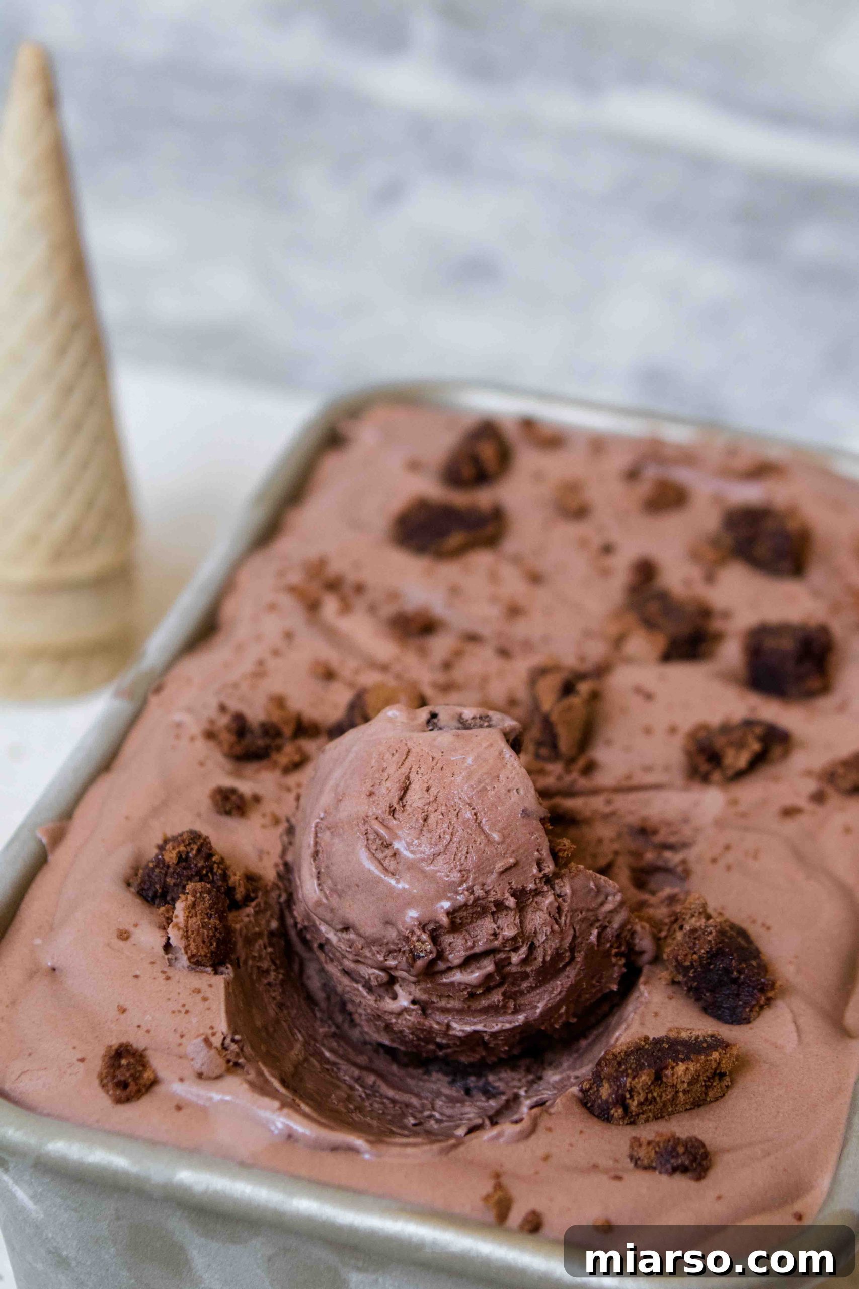 A large tub of easy chocolate brownie ice cream at home.