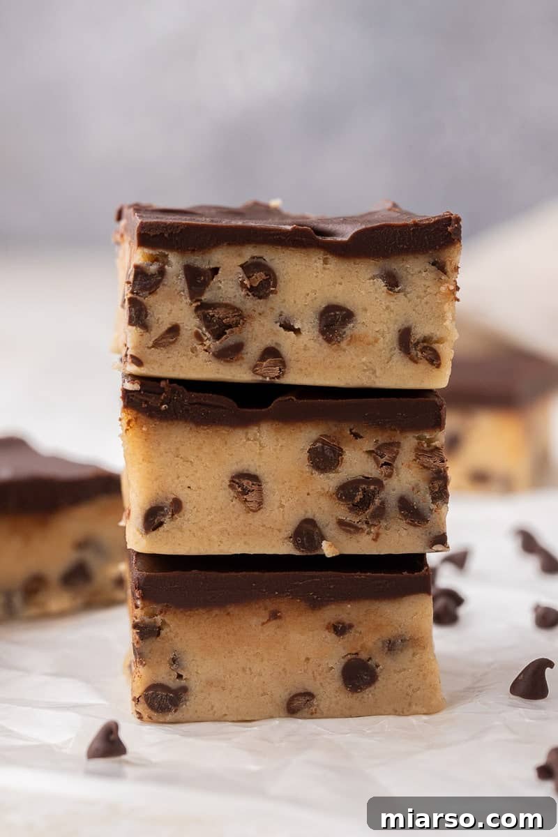 A stack of delicious chocolate chip cookie dough fudge bars, rich and inviting.
