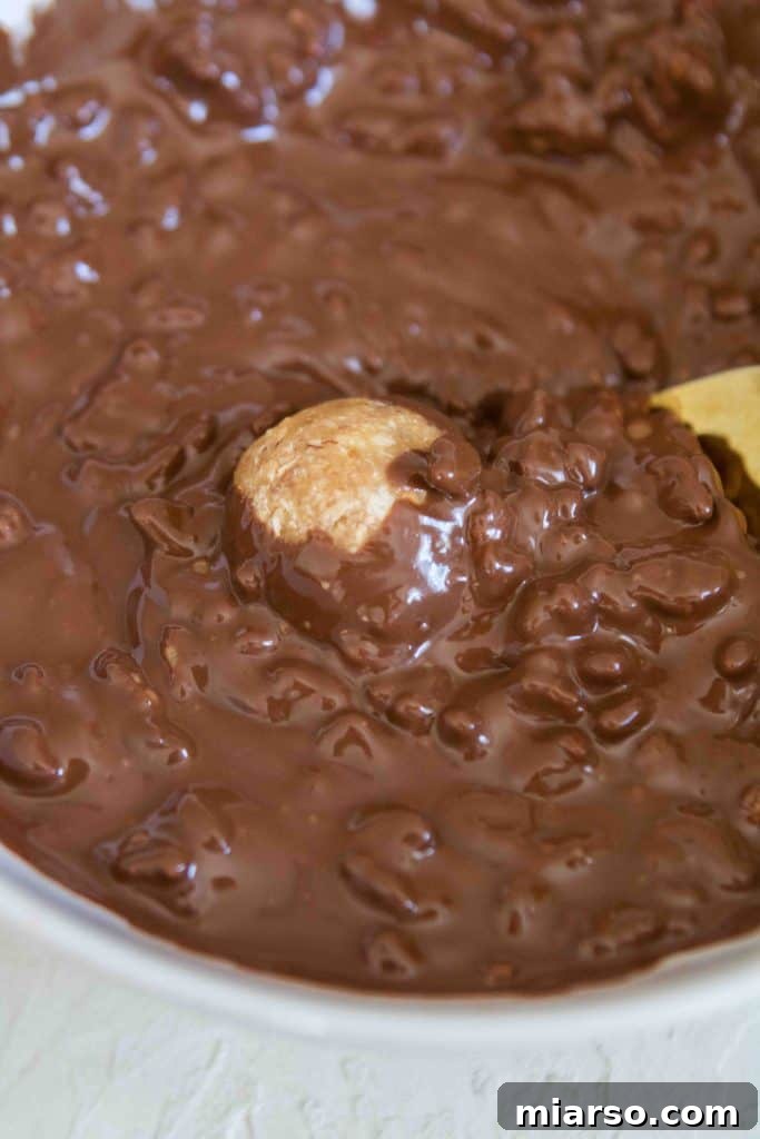Adding rice krispies to melted chocolate