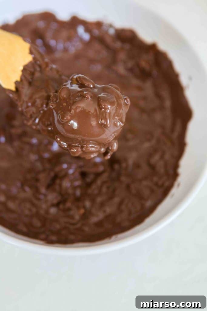 Mixing rice krispies and chocolate for the coating