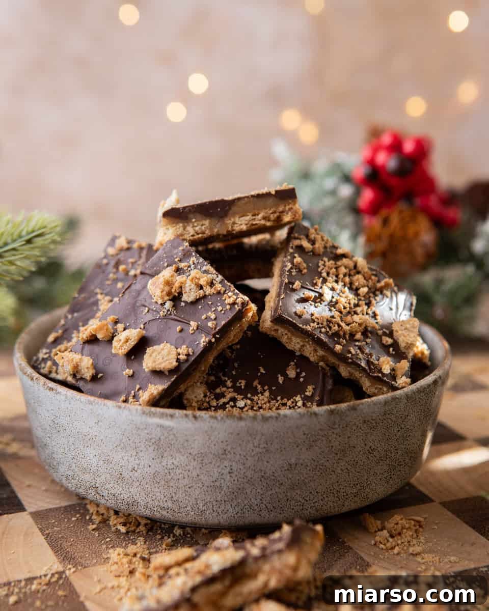 Bowl of graham cracker Christmas crack with chocolate and toffee layers