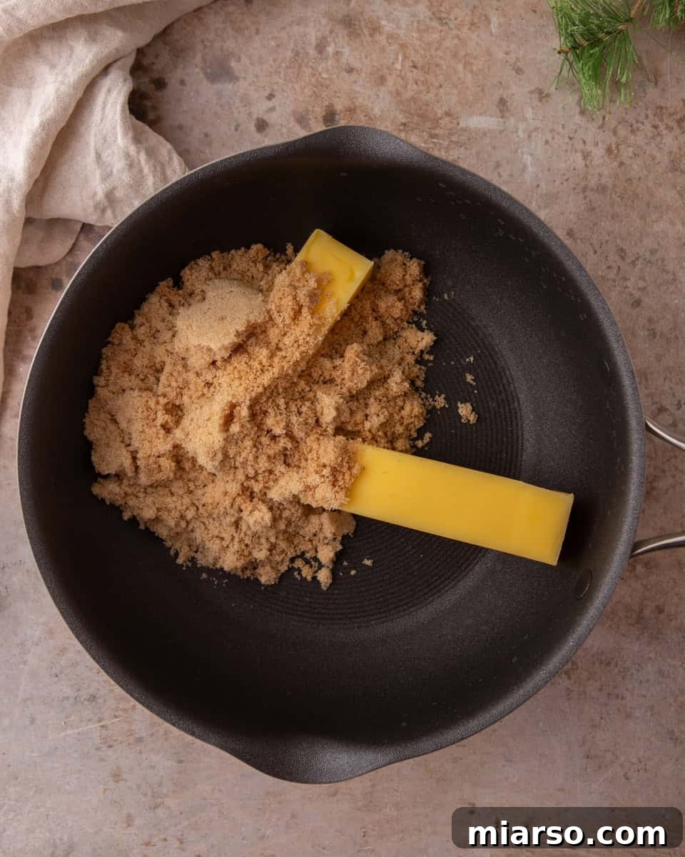 Butter and brown sugar in a saucepan explaining the toffee base