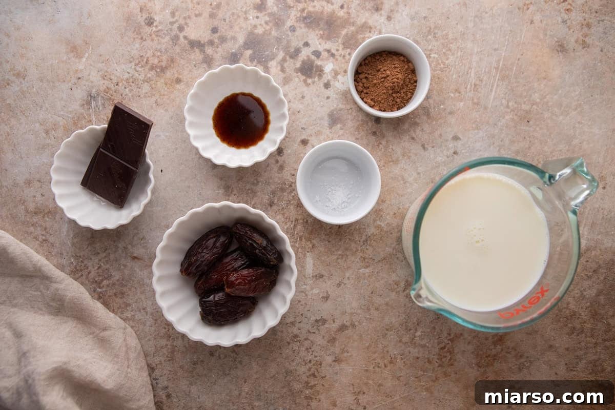 Ingredients for date sweetened hot chocolate arranged on a countertop