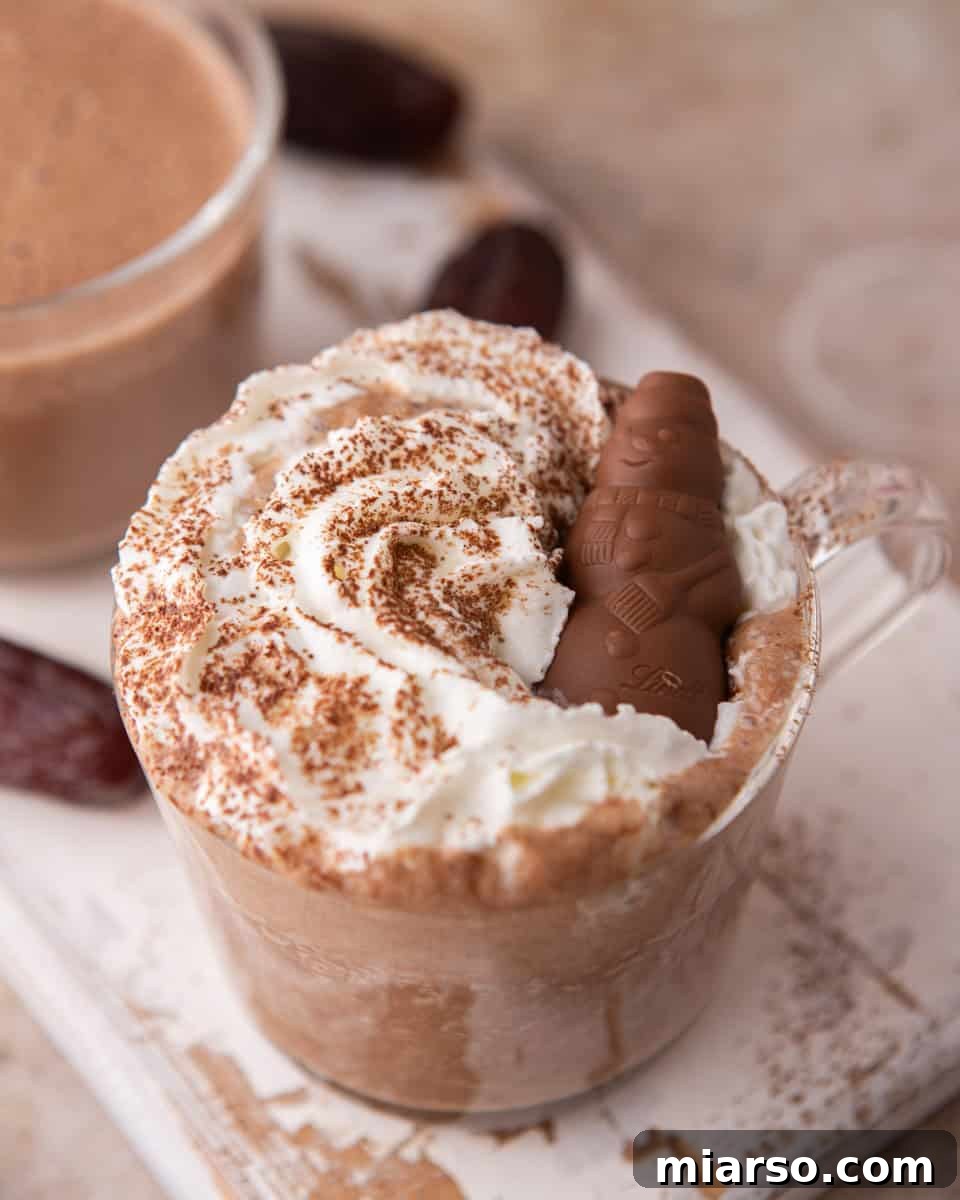 Close-up of date sweetened hot chocolate topped with whipped cream and chocolate