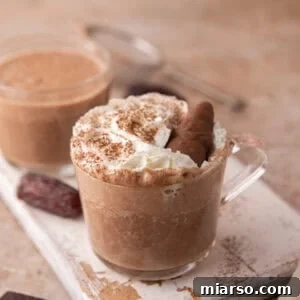 Creamy date sweetened hot chocolate served in a glass mug