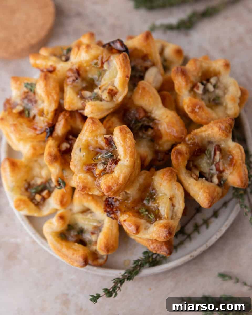 Brie and fig jam puff pastry cups baked until golden brown and topped with pecans