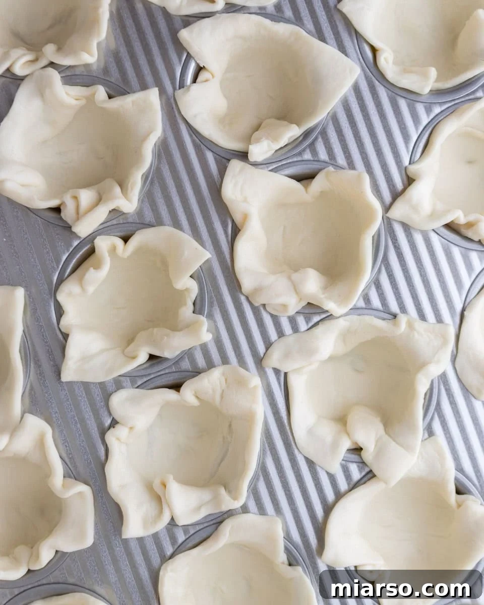 Puff pastry pressed into a mini muffin tin to form cups