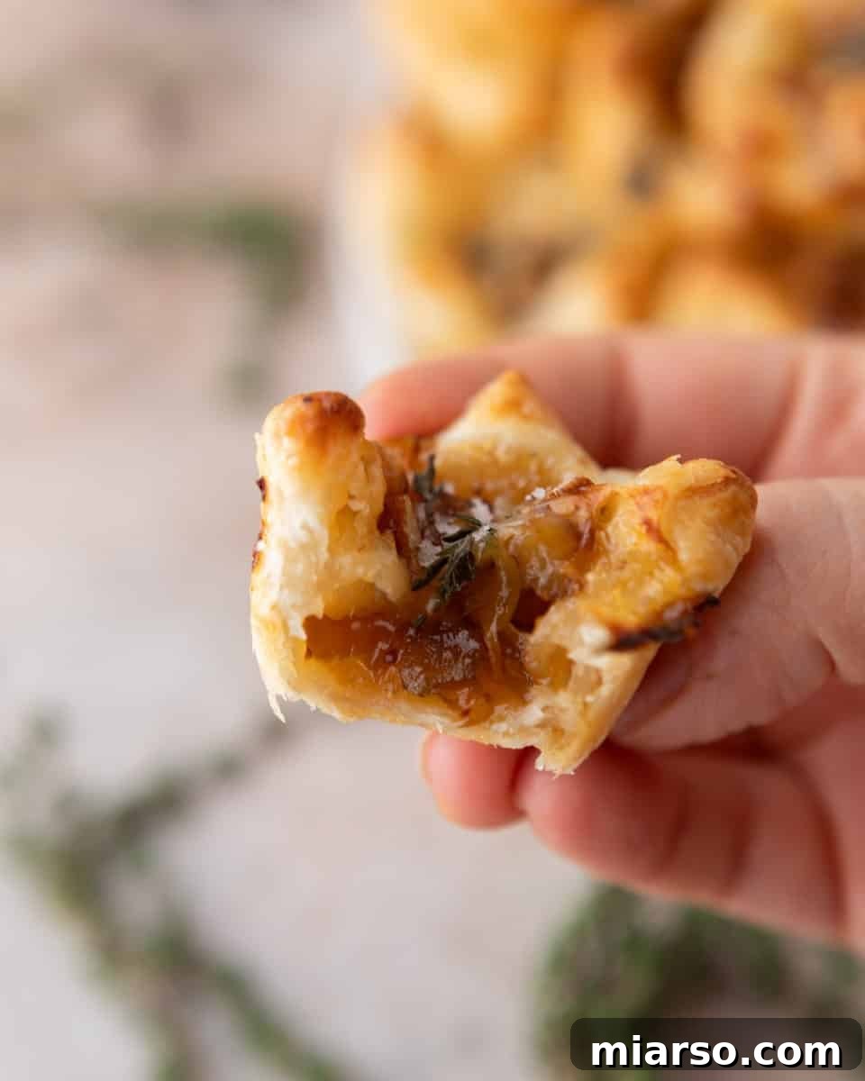 Bite taken out of a brie and fig jam puff pastry cup