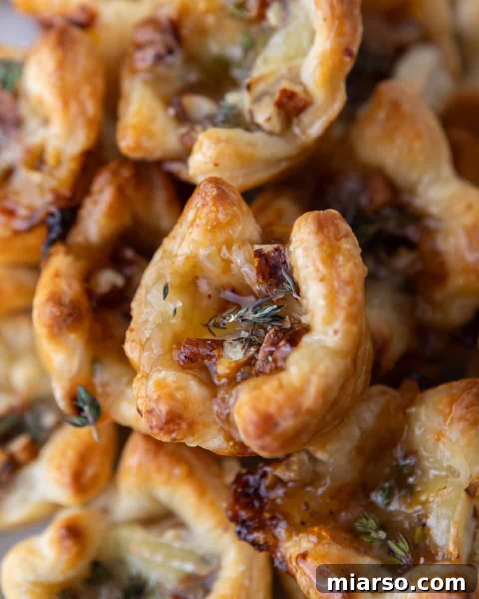 Close-up of flaky brie and fig jam puff pastry cup