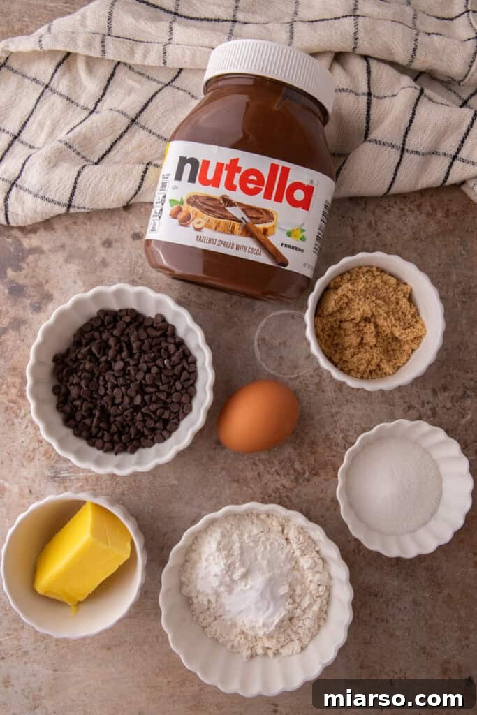Stack of split Nutella chocolate chip cookies showing molten Nutella filling