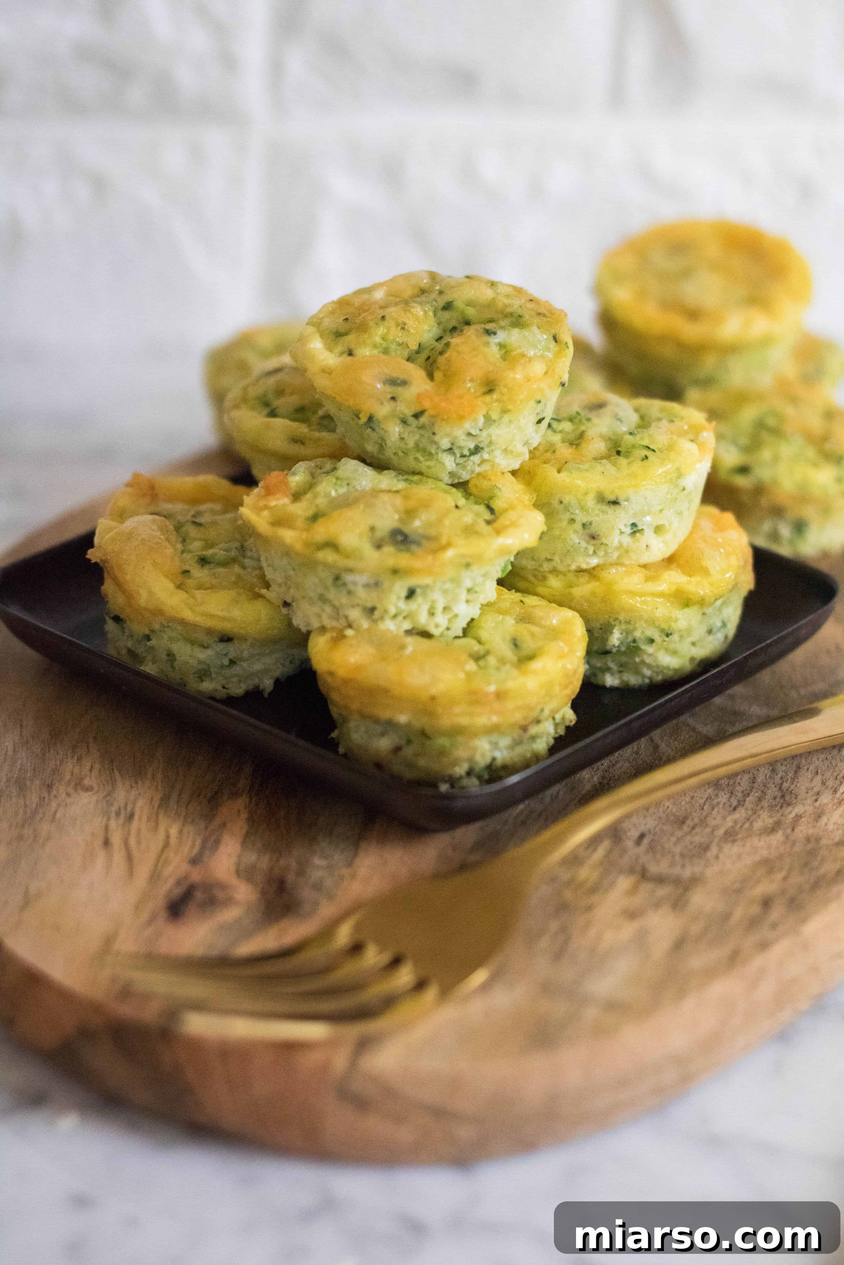 Speedy Zucchini Frittata Muffins 5 A large batch of freshly baked mini zucchini frittatas on a tray, ready for meal prep