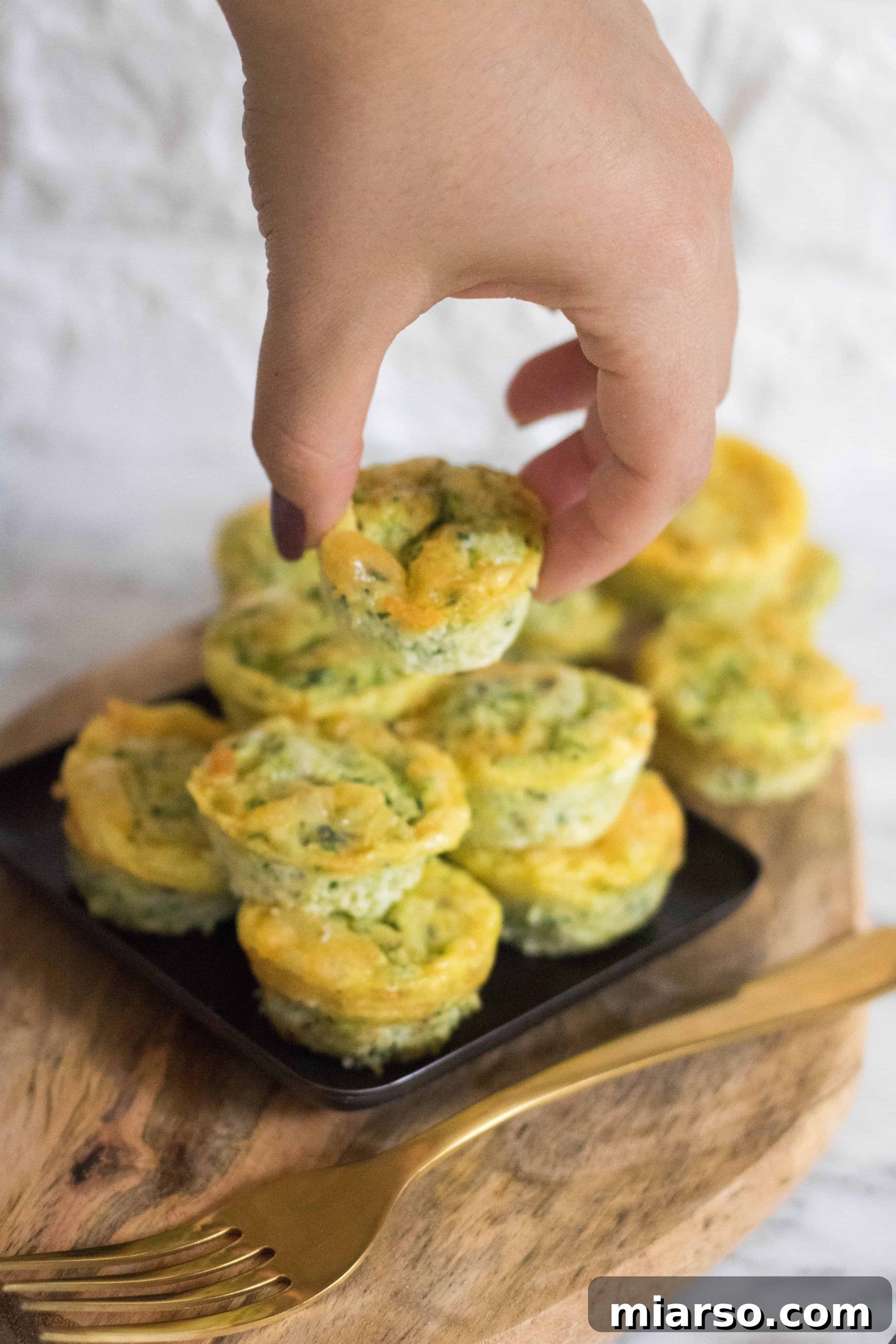 Speedy Zucchini Frittata Muffins 3 A plate of golden brown mini zucchini frittatas, ready to eat