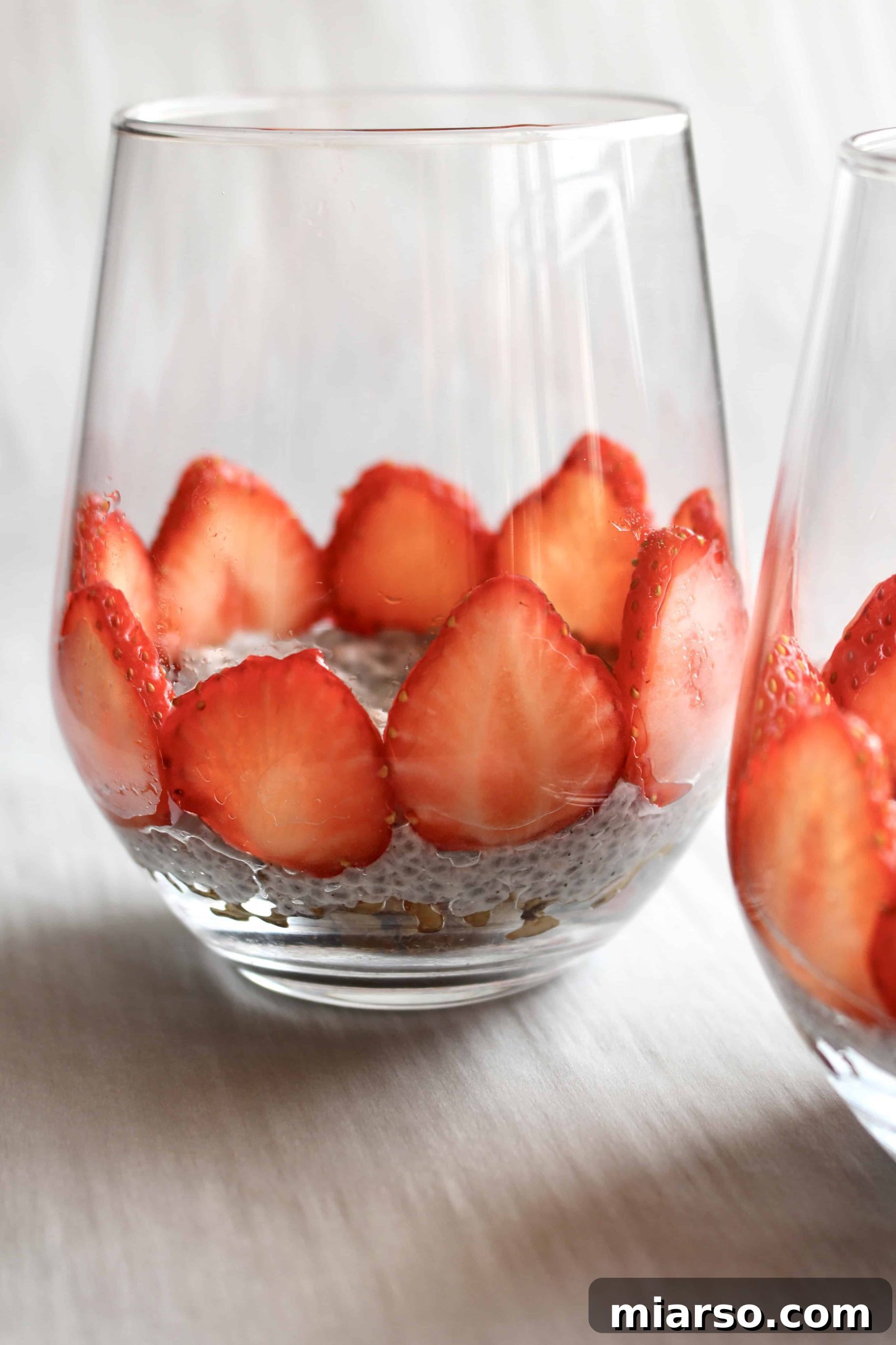 Beautifully layered chia seed parfait with fresh strawberries and creamy pudding, ready for a healthy meal