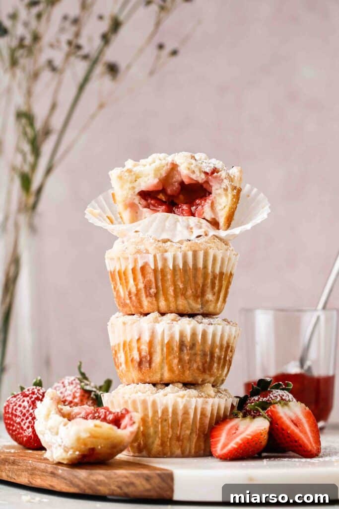 Stack of luscious strawberry stuffed muffins with streusel topping