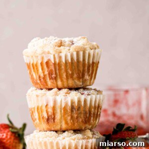 A stack of strawberry muffins with streusel topping
