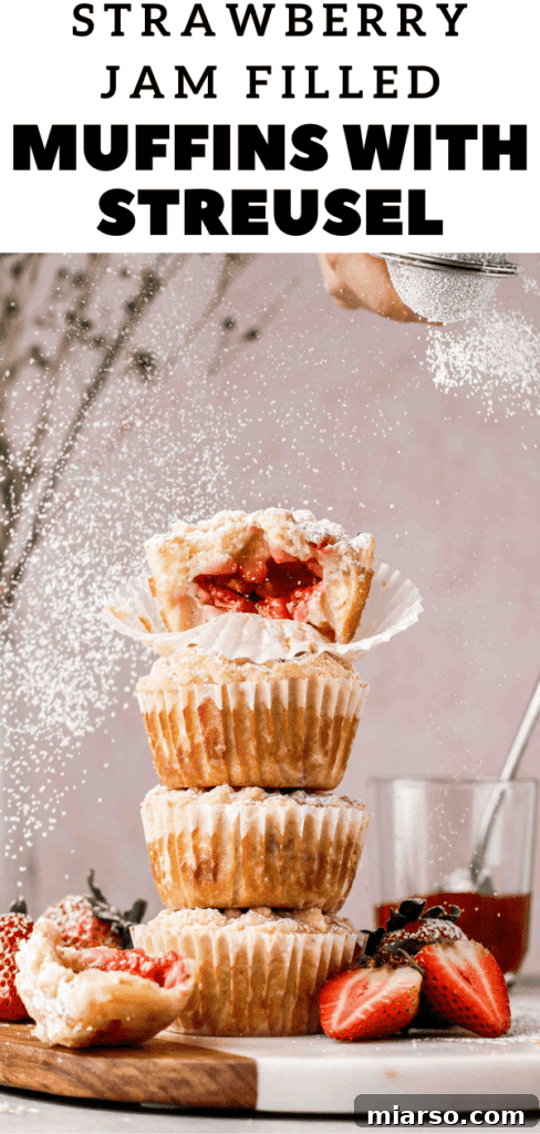 Appetizing shot of multiple strawberry muffins with golden streusel