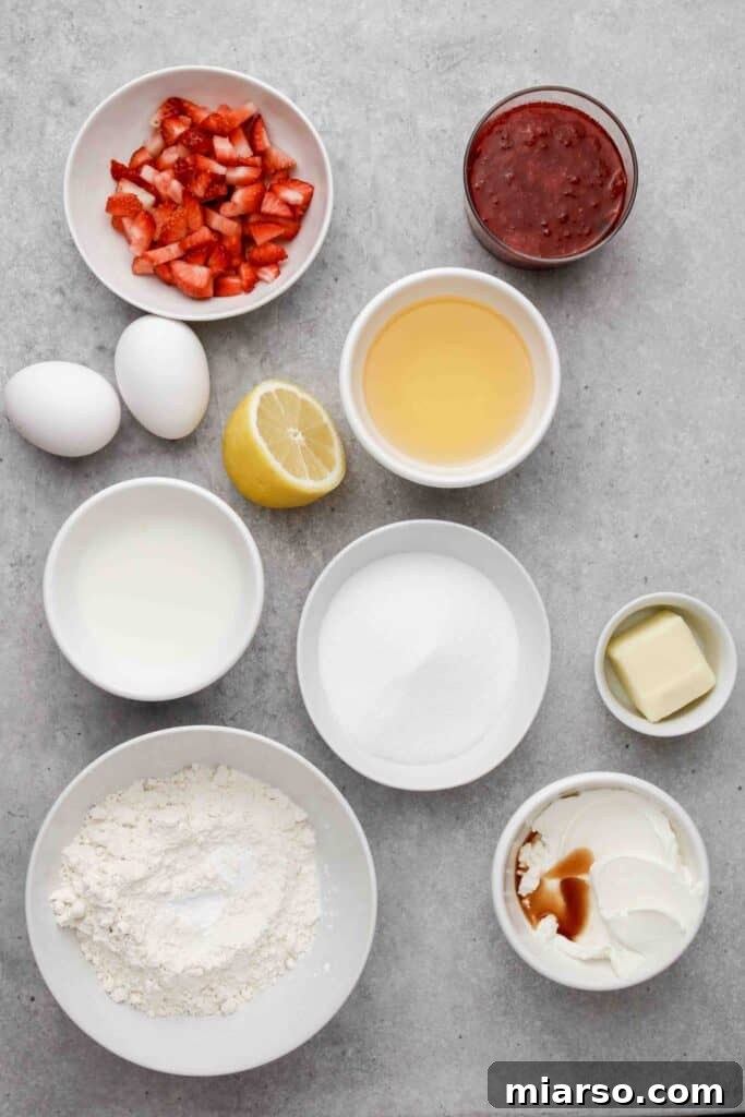 Fresh ingredients laid out for making strawberry jam filled muffins