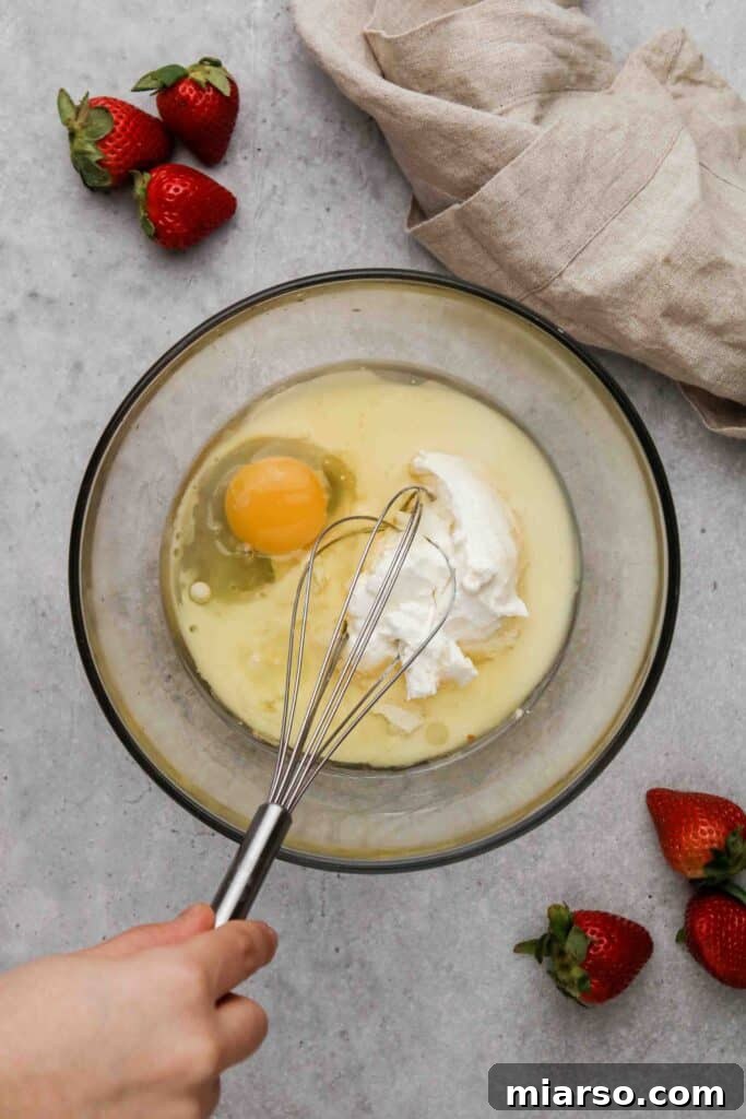 Wet ingredients being whisked in a separate bowl