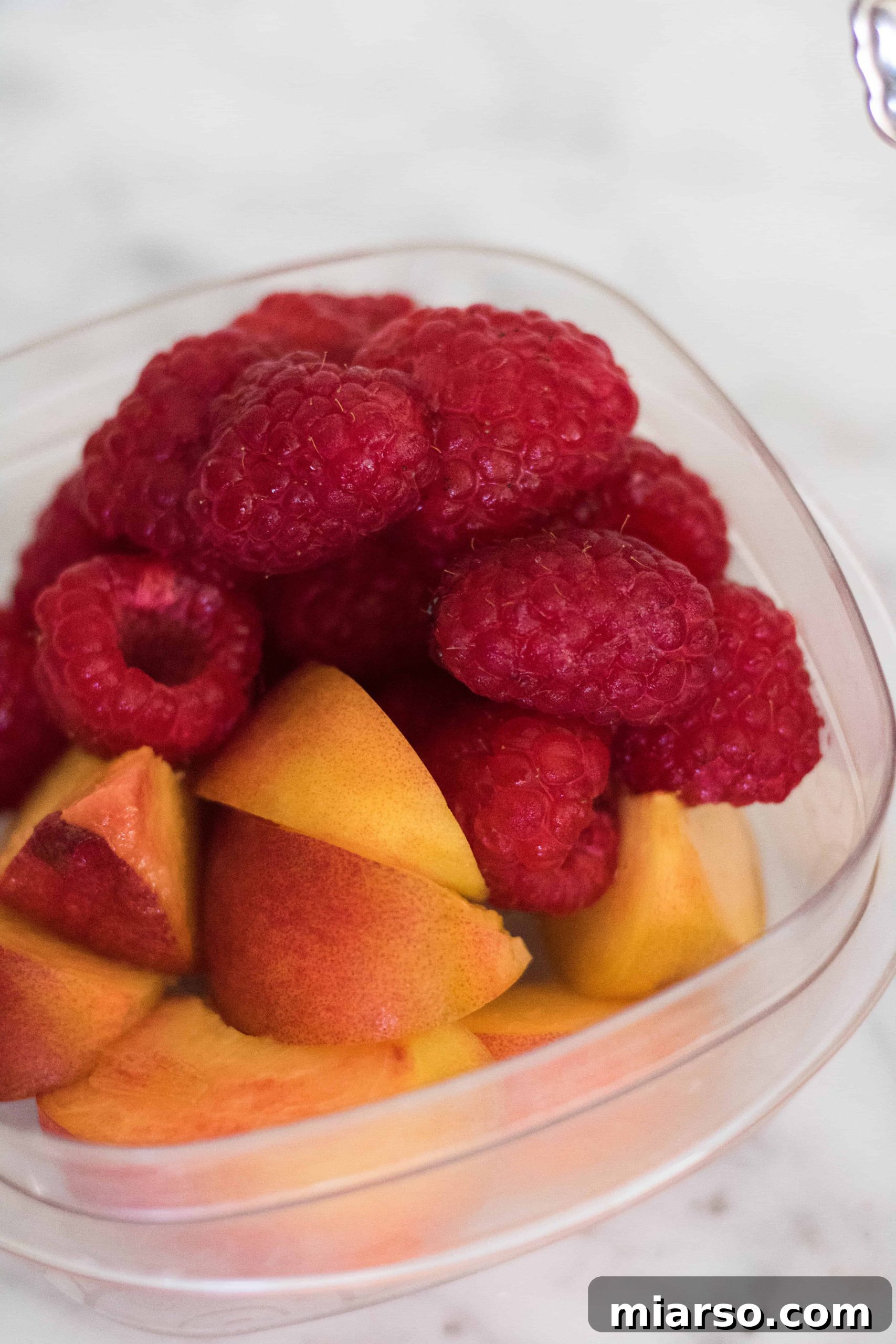 Fresh raspberries and peaches