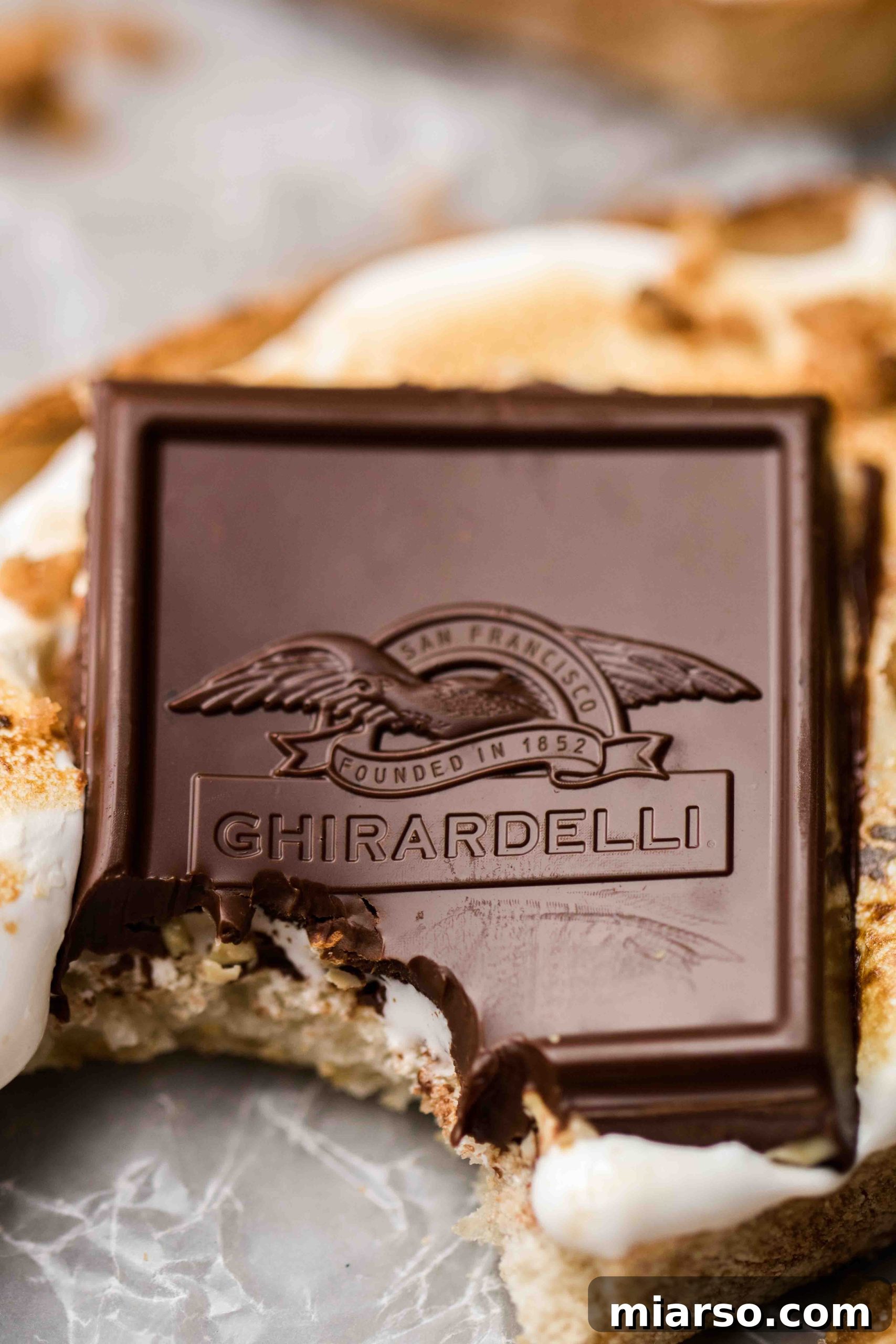 Ghirardelli intense dark chocolate squares with sea salt and almonds, ready for a gourmet dessert.