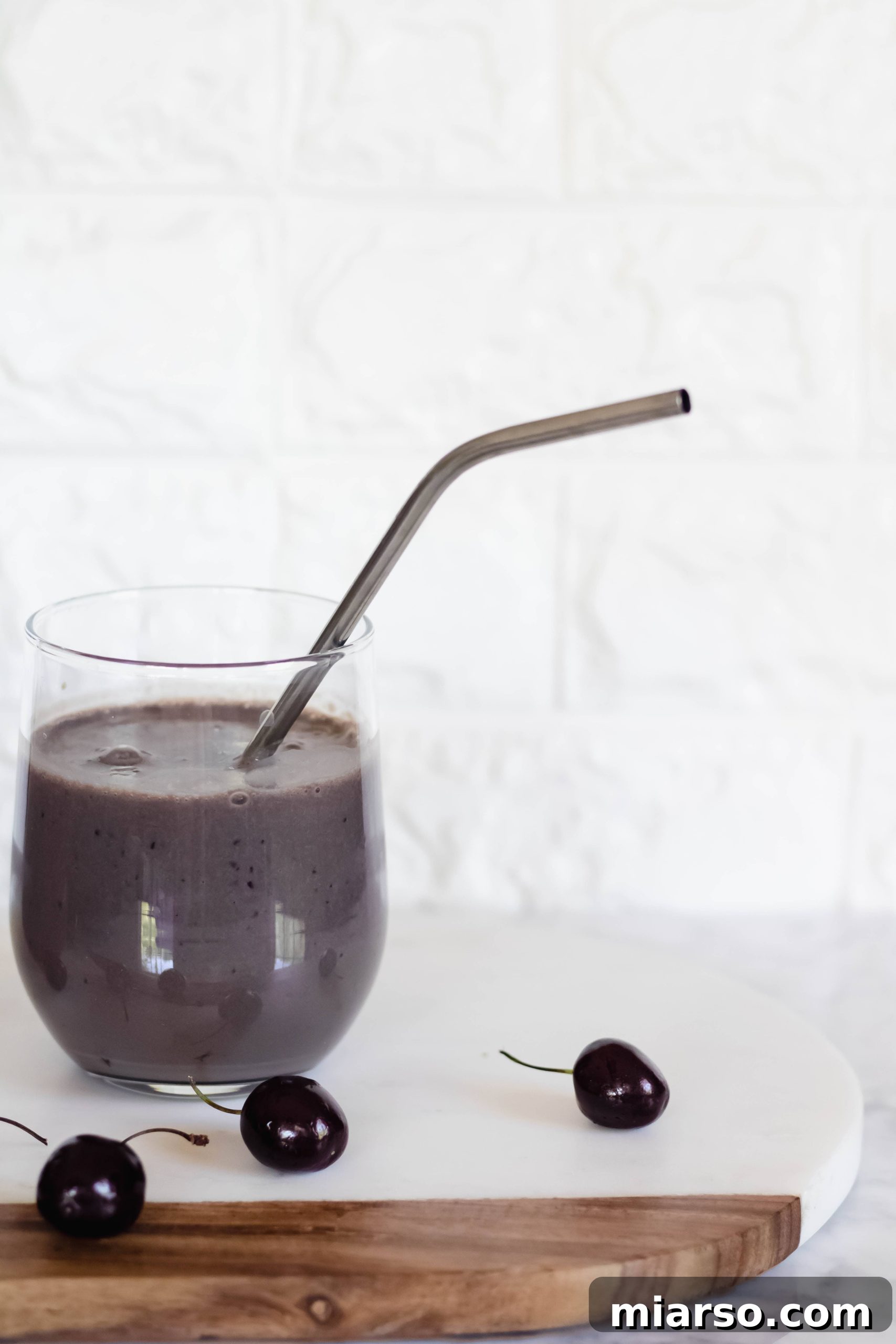 Close-up of a Vegan High Protein Chocolate Smoothie with a metal straw