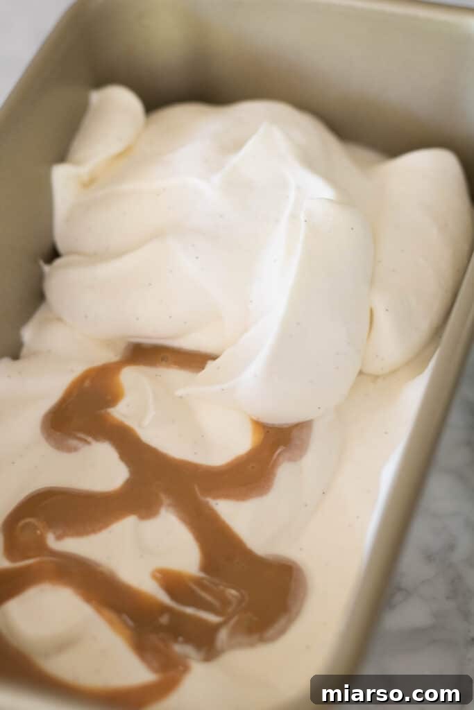 Gently folding whipped cream into the dulce de leche and vanilla mixture